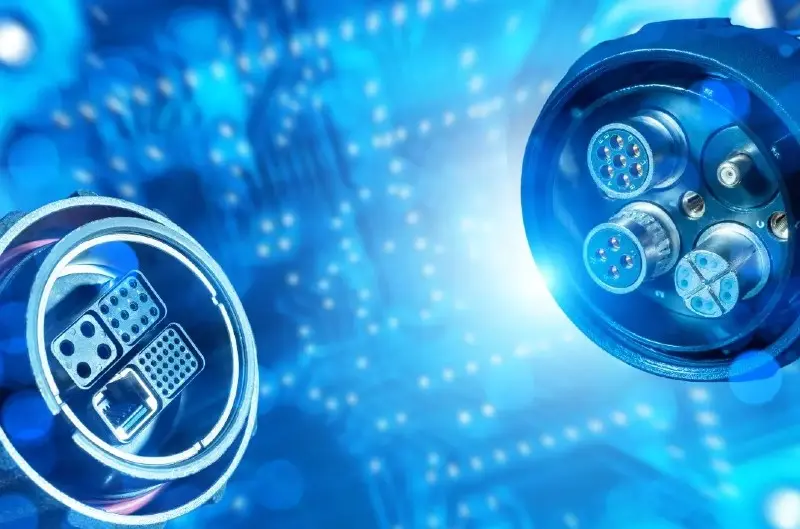 Product image: Two robust blue circular industrial connectors with pin contacts (left with cable connection, right front view) against a digital blue network background.