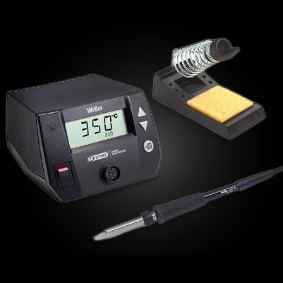 Soldering station with digital display, soldering iron, and soldering stand with cleaning sponge on a black background.
