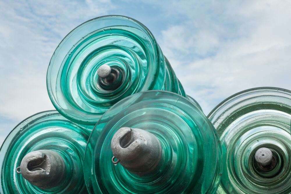 Glass disc insulator units used in suspension insulator strings for high-voltage transmission lines.