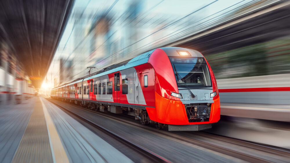 Halbleiter in Bahnsystemen: Ein elektrischer Personenzug fährt mit hoher Geschwindigkeit durch die Stadtlandschaft